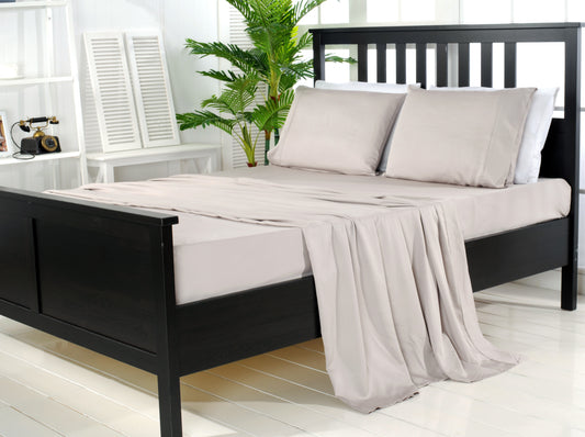 Grey bamboo bed sheet set with pillowcases on a dark timber bed